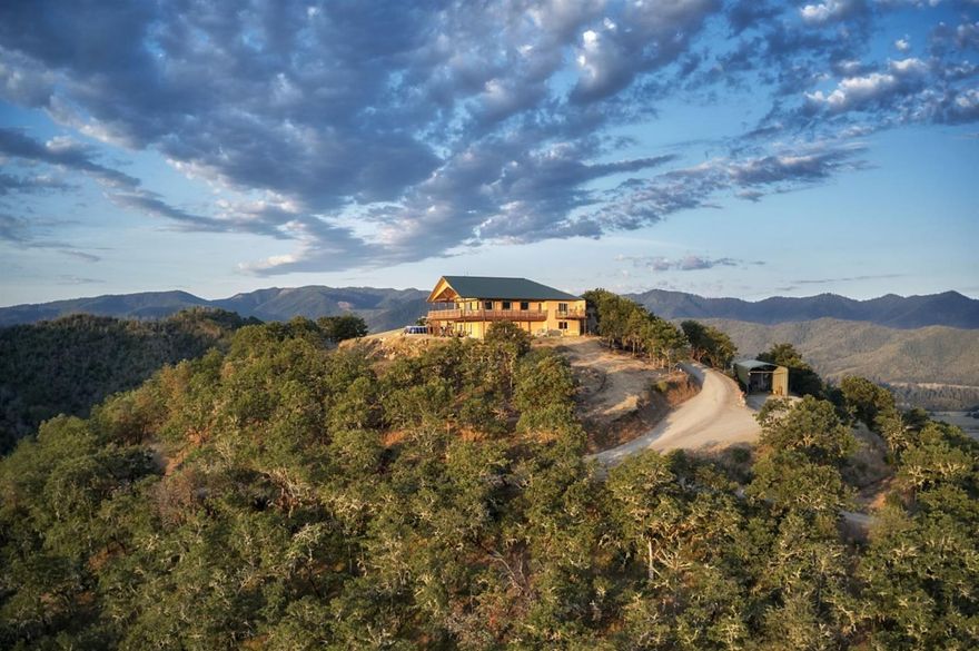 Enjoy top of the world views of the Rogue Valley and many of its landmarks from this amazing home. Situated on over 80 acres with end-of-road privacy you'll enjoy all that this home has to offer. The 3806 square foot home offers an open floor plan and was designed and constructed to take advantage of the views that are offered. Comfortable main level living is a signature trademark of the home combined with a daylight basement which provides a space all its own for an assortment of uses. This two bed, two bath home is open and bright featuring large windows. Quality craftsmanship with a purposeful design can be noticed throughout. Adjacent to the home is a garage/guest quarters that has its own private deck with views with the under story featuring a space for a large RV and a shop space. The property is well situated for horses with a barn, tack room and loafing shed. Views include the Rogue River, Table Rock, Mt McLoughlin, the Cascades, orchards and vineyards including Del Rio.