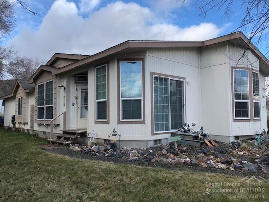 Nice MF Home In Dayville! Located on .39 of an acre gives you plenty of room for country living, 2003 Marlette MF home, 1553 sq ft with covered porch, open floor plan, kitchen features an island, breakfast nook & built in hutch, living room, dining room w/slider leading to beautiful rock garden, utility room, 3 bedroom, master w/2 closets, 2 bath, master with stall shower & garden tub, forced air electric heat, oil monitor stove, composition roof, chain link and privacy fence, irrigated by Cummings Ditch large carport, driveway and street parking. $140,950 #1025