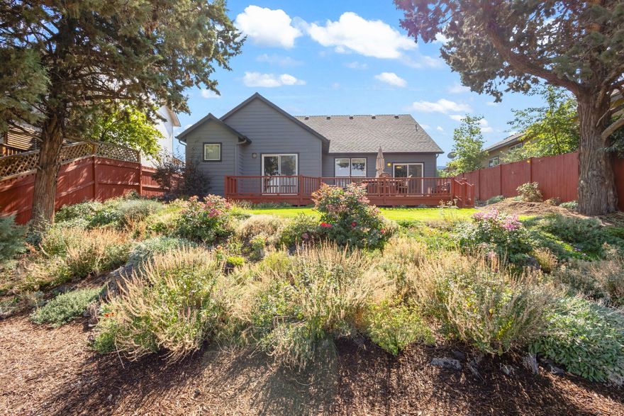 Immaculate single-level home in a quiet NE Bend neighborhood, backing to a peaceful canal and surrounded by low maintenance gardens on a .26-acre lot. Thoughtfully updated with circular-sawn Beartooth Hickory solid wood flooring, new dishwasher, microwave/vent, a whole-home automatic backup generator, accessible primary shower and more. The light-filled Great Room features canal views and flows seamlessly into the Kitchen with granite countertops, stainless steel appliances, a large island, and even a pantry. The spacious Primary Suite offers views, deck access, dual vanity, and walk-in closet. Two guest bedrooms, a full bath, and a versatile and spacious office/4th bedroom complete with a window seat. Wide hallways and doorways provide both comfort and accessibility. Enjoy serene outdoor living on the large deck, perfect for entertaining. Close to parks, trails, schools, and Eastside amenities. A true gem blending pride of ownership, beauty, function, and location!