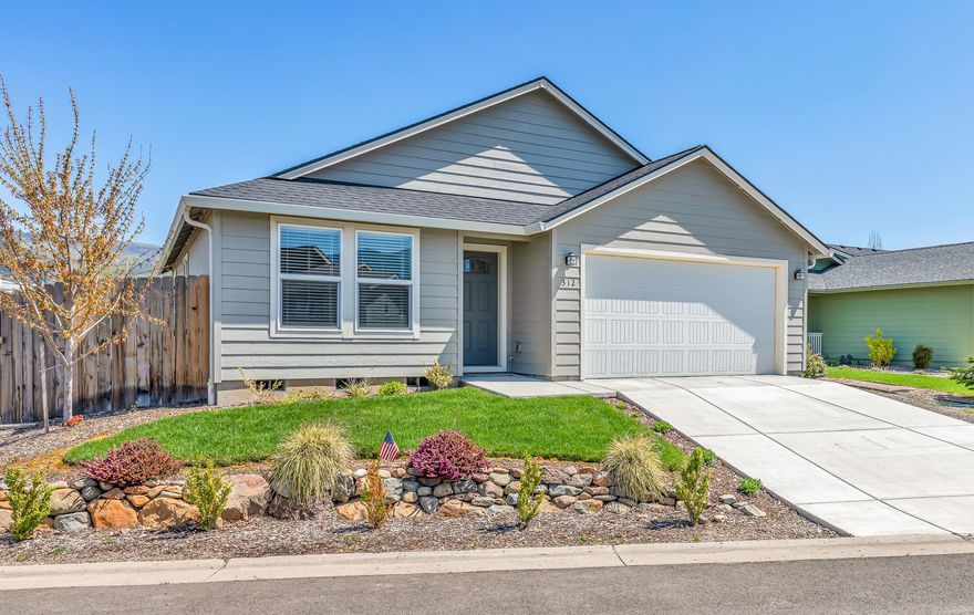 Sweet home in Oak Valley 55+ community in Talent. Just like new! Built in 2022, with over 1500 square feet of living space, this single level open floor plan contains custom cabinets, granite counters, stainless steel appliances, vaulted ceilings, nearly new laminate flooring throughout. Double vanity and walk in closet in the primary bedroom. Nice fenced backyard with cedar fencing and attractive low maintenance landscaping in the front. This extremely energy efficient home includes access to the community HOA clubhouse and pool.