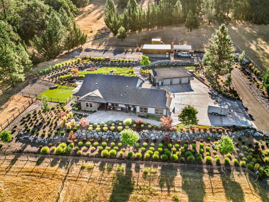 Luxurious living in captivating country. Minutes from the Famous Rogue River, this upscale modern home is a Dream! Gourmet kitchen, with top-of-the-line appliances, double ovens, pull outs, quartzite, & amazing pantry. Vaulted ceilings and radiant heated floors throughout. Enjoy the stunning fireplace and upscale beautiful wet bar. Low maintenance, built for comfortable Classy Living, horses, cars or just enjoying the views. Secluded, spacious and gorgeous make this property the ideal place for a family or professionals. Gentlemans Shop or ADU. Close to1200 sq ft- with full bathroom, kitchenette and storage. Large, insulated Horse barn includes all gates and plenty of power on this property for car lifts or agriculture. Equestrian property is fenced and cross fenced with several different areas for ease. Gated entry, clean water, great well, beautiful landscaping, custom backyard and Japanese soaking tub. Efficient, Stunning, First-Class living. Call & visit anytime.