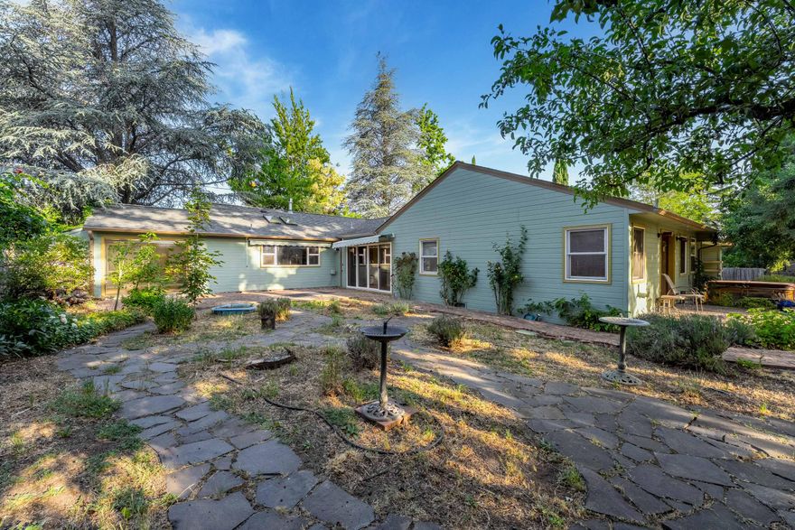 Welcome to your private retreat in the heart of Ashland! This spacious 4-bedroom, 3-bathroom single-level home boasts 2,558 square feet of thoughtfully designed living space on an expansive 0.41-acre lot. Surrounded by mature landscaping and park-like grounds, this property offers a serene escape with all the conveniences of city living just moments away.

The heart of the home is the oversized kitchen perfect for the home chef or entertaining on a grand scale. Multiple living and dining areas provide flexibility for gatherings, hobbies, or quiet evenings at home. Generously sized bedrooms, including a private primary suite, offer comfort and privacy. Plus, the sauna creates your own personal oasis!

Located close to Ashland's renowned theaters, restaurants, shopping, and outdoor adventures, this home combines natural beauty with unbeatable convenience. Whether you're enjoying the lush outdoor space or hosting friends in the spacious interior, this property truly has it all.