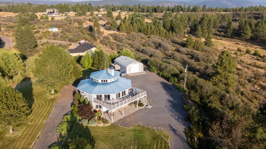 Mindful & serene living with 360 degree views of the Cascades, Crater Lake Park, Agency Lake and Pelican Ridge! This custom 2,357 sq ft, 3 bedroom, 3 bathroom home sits atop a hill on 1.57 acres. It offers ample living and storage space, including a possible 4th bedroom and loft with views galore. Lopi pellet stove, certified Defiant wood stove and heat pump ensure you'll enjoy comfortable living no matter the season! Oil-fired boiler supplies radiant floor heat, as well as hot water throughout the home. Solar assist water heater provides all of the hot water from early spring to late fall. Wired into an auto disconnect service panel is a 7kw Generac Guardian back-up generator. 2 car garage on the lowest level of the home, PLUS a fully wired shop with 100-amp panel, 220, full bathroom, forced air and wood stove for heat, and two exterior 30-amp RV hook-ups. From the deck or yard, you'll enjoy the well manicured yard, abundant wildlife and incredible sunsets. Apple, pear and plum trees