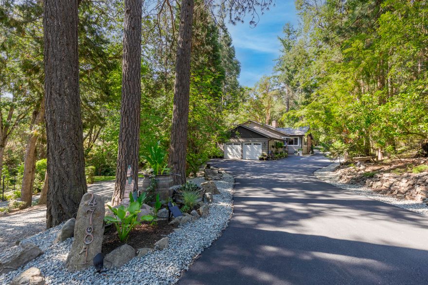 Welcome to your own private estate in Southern Oregon. This beautifully maintained 3 bedroom, 2.5 bath home sits on just over two acres of pristine, park-like setting with Coleman Creek flowing gently through. The property includes Talent Irrigation rights, perfect for maintaining the lush grounds or cultivating a garden. Inside, you'll find soaring vaulted ceilings, hardwood floors, and a spacious family room that's perfect for relaxing or entertaining.  The fully remodeled 640 square foot guest house has its own power meter and septic system, offering flexibility for guests, extended family, or potential rental income. All structures have 50 year presidential roofs that were installed in 2018, providing lasting quality and peace of mind. Private, peaceful, and beautifully kept, this is a rare find in an exceptional location.