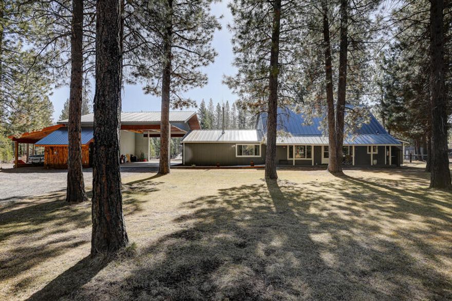 A beautifully updated special home on a private tranquil treed 10-acre parcel backing BLM land.  You will love Country living close to town with this warm, inviting spacious 2528 sq ft home with a huge 32X80 Shop featuring 4 Garage Doors and a ½ bath.  The home features a New Carport w/ attached storage/Lean to, RV/Boat Parking, Wood Stove, Mudroom, 2nd floor balcony overlooking the spectacular groomed property with big, majestic ponderosa pine trees with plenty of space for Horses or build a Barn, Arena.  The newer updates & renovations include: Well & well house, Metal Roof, Flooring/Carpet, Custom made Kitchen/Bathroom Cabinets/Counter Tops, Sinks/Toilets/Showers/Faucets, Kitchen Range, Dishwasher, Garbage Disposal, Microwave, Light fixtures, Interior doors/frames, Underground sprinklers, Septic Tank, Paint (interior/exterior), Gravel Driveway, 2 Heat Pumps/2 Furnaces and Concrete Sidewalk/Patio w/ ADA ramp.  Easy access to stores, restaurants, Highway 97, lakes, rivers & hunting.