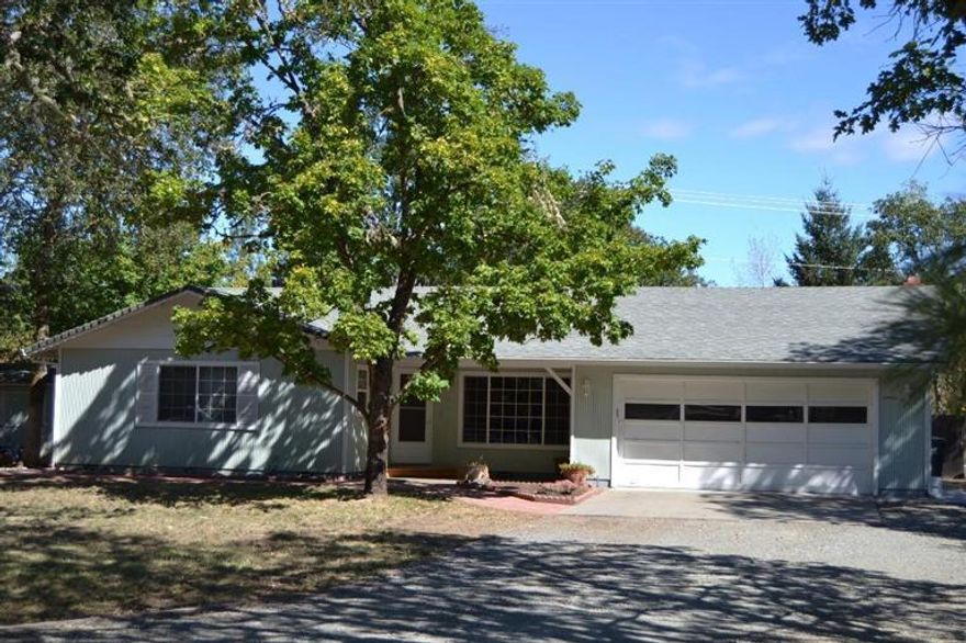 Great location in Colonial Valley just mins to downtown Grants Pass. Located on almost an acre with 1960sqft 3 bedrooms & 2 baths, this fantastic home features living room, large family/ game room, lg dining room, fireplace plus a wood stove in the family room. Outside is a very large backyard with covered deck area, garden area and plenty of room for Rv,boat, or other toys. Fully fenced front and back.Property backs up to just before the creek which gives you the privacy of no neighbors behind. Wonderful country setting only mins to downtown.The one you've been looking for is here, don't miss it.