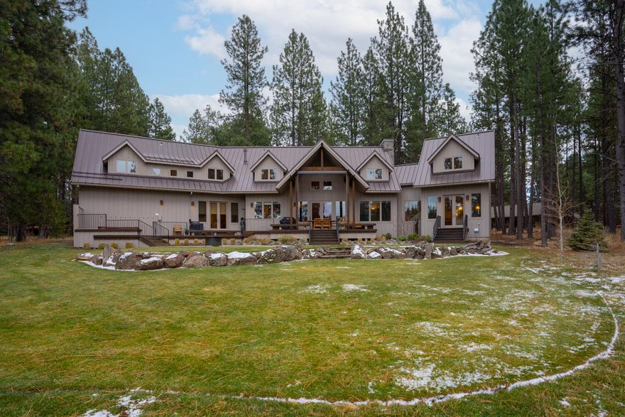 Serenely located aside Glaze Meadow & Heron Lake, this beautiful Northwest inspired home, delivers custom design w/both privacy & entertaining in mind. This 5 bedroom, 5 1/2 bath home presents numerous options for those peaceful days/nights at the ranch. The great room centers the home w/large cathedral ceilings, picturesque windows, modern angle design, exposed beams, and floor-to-ceiling stone fireplace. The primary bedroom is located on the main floor & includes a spa-like bathroom, complete with European-style cabinets & heated tile floor. An entertainers kitchen invites for large or quant parties, family gatherings, or just a chef's space w/an adjacent butlers pantry. Upstairs provides space on both ends of the home w/ two private bedrooms en- suites, a large & open bonus room, and two chic bunk-style rooms. The outdoor living space 
 is designed w/play, style and function in mind. Recent upgrades include new furnace, heat pumps, Nest climate control, and new kitchen tile.