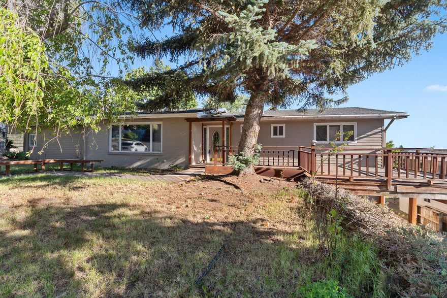 This gorgeous home stands proud on a good-size lot and is perfectly positioned right at the end of the road ensuring a private peaceful home setting. Two level home that provides soft natural light that illuminates the open-concept layout. Two generous living rooms provides ample space  for either a two household or one large household unit. Large dining area along with a well-equipped kitchen with tiled countertops, quality appliances and abundance of cabinetry. Four good-size bedrooms and three bathrooms extend the floorplan ensuring ample space for everyone. Hosting guests will be a joy with expanses of decking where you can cook on the grill, dine outdoors or simply bask in the sunshine and admire the serene surrounds. RV or boat parking, mature trees and lush lawn with plenty of room to add your own touches.