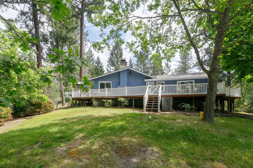 Location, Location, Location!
This one is calling your name! Located in the beautiful & desirable Country Club Heights subdivision. This home is set within walking distance to Cathedral Hills hiking trails AND the Grants Pass Golf Course! Just 10 minutes to the heart of Grants Pass with city schools and county taxes! What a score!
The home features a single story, open concept living space perfect for entertaining! The dining area steps right outside to the newly built, fully enclosed wrap around deck with beautiful wooded views! Interior features of the 2,364 SqFt home include 3 bedrooms, 2 full bathrooms with walk in showers & a jetted tub in the primary; a nice size kitchen with a dreamy commercial refrigerator; a game/media room ready to host and hang; and so much more! Outside you'll find a detached 2 car garage & a fenced in garden area with lots of sunlight exposure. With its prime location and a little bit of everything, this is the perfect place to call home!