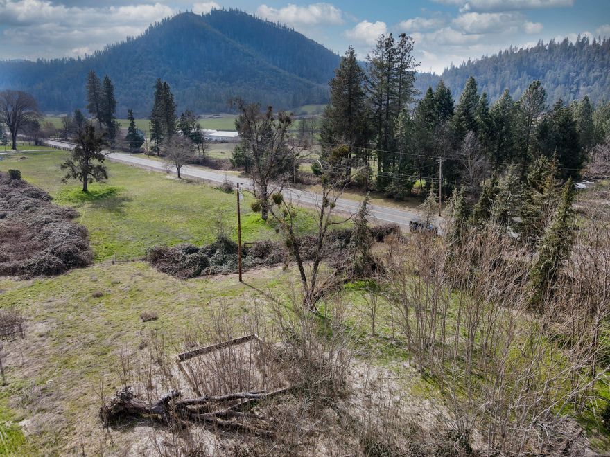 This 1.03-acre vacant lot offers a unique opportunity to create your perfect retreat in the stunning Applegate Valley, a highly sought after region of Southern Oregon. The lot is ready to build with a septic system already in place, utility access, and a well that's already drilled—saving you time and money on the essential infrastructure. The property sits between two large parcels, giving it a spacious, open feel that extends beyond the acre. Enjoy the serenity of country living with the convenience of being centrally located between Jackson and Josephine County. Whether you're envisioning a peaceful homestead, a getaway, or your next big project, this lot is the ideal foundation. Don't miss your chance to secure a slice of Southern Oregon paradise in the coveted Applegate Valley!