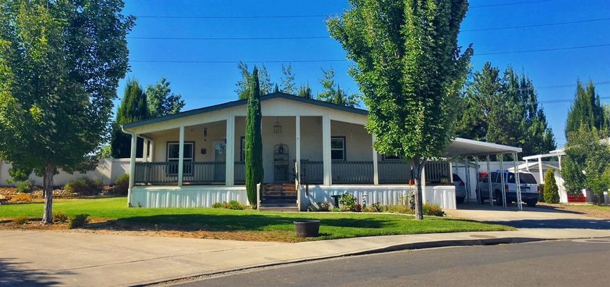 Fantastic home in a great location in San George Estates family-oriented community in Southern Oregon! This fabulous triple wide manufactured home offers 3 spacious bedrooms, 2 baths, 1920 sq ft of living space and nestled on a large corner lot. Super great open floor plan and vaulted ceilings throughout making it great for entertaining! The sizable master has huge walk in closet and large private bath with skylight drawing in lots of natural light. Enjoy your summer evenings from the expansive wraparound deck with built in wheelchair ramp. This home comes complete with 2 storage sheds, workbench, raised garden beds, carport, and access to the parks wonderful clubhouse, pool, exercise room, playground, library and RV storage! Don't miss this opportunity to be a part of a one of a kind neighborhood close to restaurants, shopping and more.