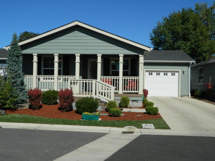 Covered Front Porch invites you into this  2016 Palm Harbor Manufactured home Located In West Lake Village a 55+ community.  1334 Sqft 3 bdrm 2 bath home with many upgrades.  Laminate flooring, granite counters, newer appliances, Covered Deck and single garage.  Great Room featuring spacious living room, sunny dining room and roomy kitchen.  Oversized Main Bedroom with walk in closets and private bath.  Laundry room with laundry sink. Professional Landscaping, Delightful Covered deck.  Space Rent $625.00 does not included water, sewer or garbage.  One 25lbs dog.