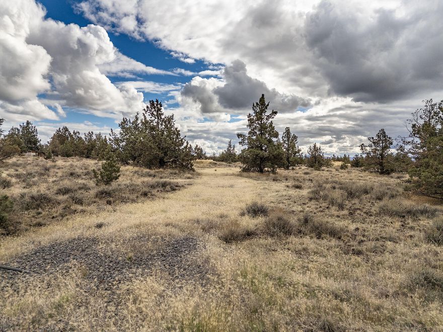 Create Your Country Dream on this 5 acre parcel in Sunny Central Oregon. This expansive property offers wide open space, endless blue skies, and stunning views of the Cascade Mountains—an ideal setting for rural country living with room to grow. The land is partially fenced and includes a roughed in entry road, creating easy access. Power is available at the road, and you'll enjoy nearby public lands for hiking, riding, and exploring. Multiple building sites give you the freedom to design your perfect home, whether you're envisioning a cozy cabin or a spacious estate. Located just minutes from town and close to the scenic Prineville Reservoir, this property offers the best of both worlds: peaceful seclusion and convenient amenities. Whether you're looking to build now or invest for the future, this open canvas is ready for your vision.