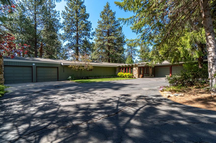 Mind blowing Magnificent Mid Century Modern Masterpiece.  The year was 1966.  Gas was 32 cents a gallon. The average price of a home was 12,500.  A little show called Star Trek made it's debut.  Miniskirts were in, the Beatles and the Beach Boys were duking it out on the radio, and this home on the Bend Country Club was built.  3 bedrooms, 2 baths, in 2733 sq ft, with a 4-car garage.  A lush fully covered indoor atrium welcomes you, transporting you from everyday life to another place and time. The huge sunken living room features an entire wall of river rock.  The ceilings are beamed and the windows are floor to ceiling.  As you enter the open kitchen you'll encounter a second beautiful river rock fireplace which is the focal point of the kitchen gathering space. Down the bedroom wing, you'll notice the generous sized rooms, and the newly remodeled bathrooms.  Completed in 2021, they enhance this otherwise 1966 classic mid-century modern masterpiece.