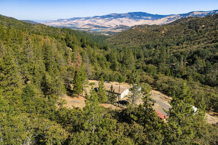 Just minutes from downtown Ashland, this 4.14-acre retreat blends privacy, natural beauty, and convenience. Nestled on a gentle hillside, the 2012 manufactured home offers 3 bedrooms, 2 baths, and 1,119 sq ft of light-filled living space. With sweeping views of Emigrant Lake, rolling hills, and the surrounding mountains, this property  creates a sense of peace and connection with nature. The property is comprised of two tax lots, providing added space and flexibility for gardening, animals, or future possibilities. Its desirable location offers the best of both worlds—quiet country living with easy access to Ashland's shops, dining, and cultural life, plus endless recreation just minutes away. Whether you enjoy hiking, skiing, exploring wilderness trails, or simply savoring the tranquility of your own land, this property offers an inviting canvas for your Southern Oregon lifestyle.