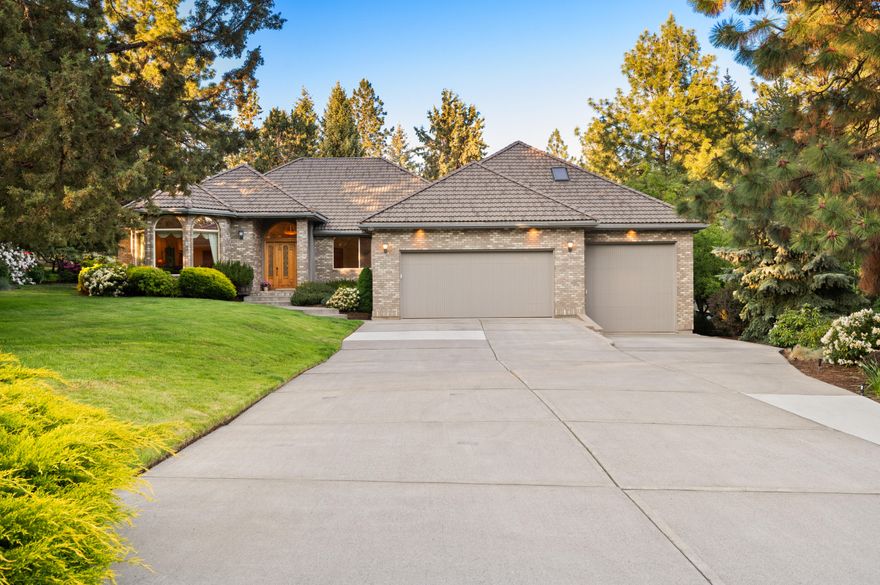 Graceful Elegance! Discover refined living in this Street of Dreams floor plan in prestigious Awbrey Butte. This 3,170 sqft home offers 3 spacious bedrooms, 2 full baths on the main floor, and a versatile bonus room with half bath upstairs—perfect for an office, playroom, or guest space. Underground dog fencing adds peace of mind for pet owners. Inside, enjoy Italian tile flooring, custom hand-sewn draperies, and thoughtful details throughout. The oversized 1,100+ sqft garage provides ample room for cars, tools, and gear. Nearly an acre of lush, mature landscaping includes 2 apple trees and offers a serene outdoor retreat. A John Deere riding mower—regularly serviced—is included for easy lawn care. The distinguished brick façade and 60-year tile roof offer curb appeal and durability. This home blends elegance, practicality, and comfort. Don't miss the opportunity to make it yours—schedule a tour today!