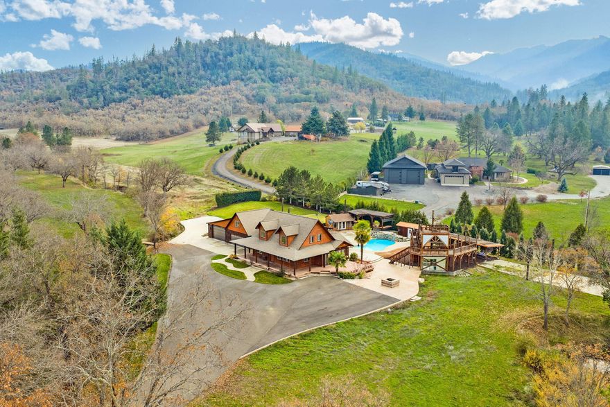 This 11.02-acre Central Point retreat is built for those who crave space, privacy, and a lifestyle that blends relaxation with recreation. The custom home offers warm, inviting living spaces with refreshed kitchen, baths, and flooring. Step outside and the property transforms into your own resort: swim in the sparkling pool, unwind in the pool house, host gatherings on the composite deck, or enjoy evenings on the patio around the fire-pit. An expansive play area with in-ground trampoline, climbing wall, and zipline keeps everyone active, while the massive putting green offers a perfect place to practice or unwind. Multiple outbuildings support any lifestyle: a 4-car garage with finished 260 ft� upper room, finished pool pump house, shed, and 2-bay RV storage. Wander the walnut orchard, relax by the pond, or simply take in the pastoral views from the porch swing. EFU zoning and open acreage offer endless possibilities, all just minutes from town yet peacefully removed from the everyday