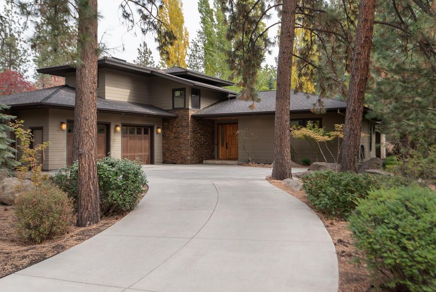 This updated, contemporary home is tucked into a quiet location in Woodriver Village  just steps to the Deschutes River Trail, riverfront parks, the Old Mill District restaurants, shops, concerts and more. At home you'll love the sleek, stylish design with striking beams, vaulted ceilings with cedar accents, windows across the back revealing the covered patio and beautifully landscaped, fenced yard. The gorgeous kitchen features a large granite island, coffee bar area, and breakfast or office nook. The main floor primary suite boasts a rich, luxury bath with large walk-in closet. The other main floor bed and bath is perfect for guests. Upstairs, an open loft and full bath can serve as an additional en suite or private office. Store your paddle boards and other toys in the oversized 786 SF 2-car garage with storage room. Live the Bend life here!