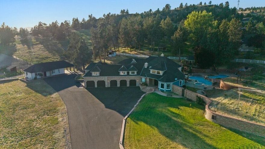 Incredible property with beautiful grounds! Situated on 3.98 acres of land just minutes out of town, with a 5 bay garage, a separately fenced acre of land that would work great for a hobby farm, 4-h, or horses, and an in ground custom pool!  The pool has 2 pools, one cascading down to the next with waterfall features, as well as an income producing detached 900 square foot 2 bed 1 bath ADU, as well as a 2 bed 1 bath pool house fully renovated and updated. There is a gazebo in the back yard as well, for gatherings and a hot tub gazebo with views of Mt Shasta. The interior of the home has been tastefully updated with new flooring downstairs, and custom hand made hemlock stained wood trim. The property has a sauna as well. Upstairs has the potential to have a dual primary set up with one of the primary's having its own entrance. A truly unique custom home with magnificent curb appeal and opportunity! All appliances included with an acceptable offer. Owner carry terms 50% down 6% interest