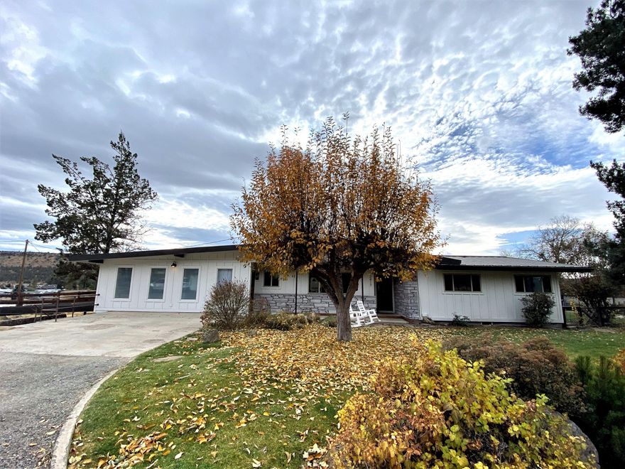 Come see these sprawling city views from this mid century modern home that sits above town on the NE side of Prineville on almost an acre. The home has been updated with still leaving tasteful touches of the original style in the home to keep his history alive!  Home offers 4 bedrooms 2 bath with attached garage and carport below the home that could be converted to bonus room if desired.  Master bedroom is separate from guest rooms for the ultimate privacy with its own private door to the gorgeous fenced back yard.  Backyard can be multilevel with top level currently fenced and landscaped beautifuly.