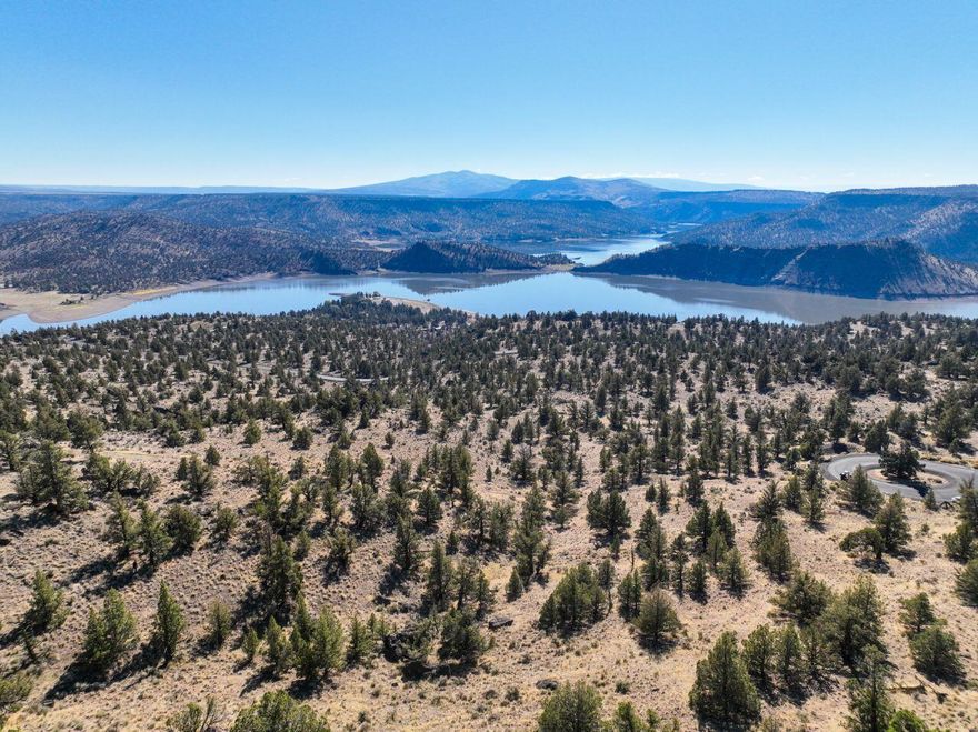Breathtaking views of Prineville Reservoir and sweeping panoramic landscapes await on this stunning 2.57-acre parcel in the private, gated community of Indian Rock Estates II. Unique rock outcroppings and mature Juniper trees create a property full of natural charm and character. With septic approval, underground utilities, and access to a community water system, with the connection fee already paid, it's ready for your dream home. The property borders Oregon Parks & Rec land, offering access to thousands of acres for endless exploration. Just 20 minutes from Prineville and 4 minutes from the State Park boat launch—ideal for boating, fishing, hiking, and enjoying the best of Central Oregon's outdoor lifestyle.