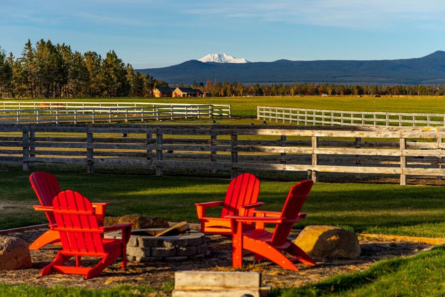 Exquisite Equestrian Property with stunning Cascade Mountain views on 25 bucolic and irrigated acres in prestigious west Tumalo.  Bright, spacious and beautifully remodeled, the home is inspired by contemporary European design and features wide plank hardwoods, vaulted ceilings, rich beams and walls of glass that showcase the views and pastoral setting.  Gorgeous upgraded kitchen, sleek glass fireplace that bridges dining and living rooms.  Patio sliders lead to an expansive deck and large grassy yard.  Primary Suite has a luxury bath, huge walk in and European style soaking tub.  Deluxe five stall barn w/tack room and bath on main floor.  Upstairs is 1,400 feet of finished living space w/balcony and expansive views.  200 X 60 outdoor riding  arena, multiple paddock options.  Hayfield has a state of the art remote controlled irrigation system.  Other outbuildings include  2,340 ft rustic barn with storage and a 576 ft loafing shed.  This one is a horse & animal lover's dream come true!
