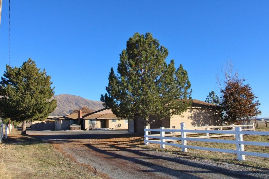 Henley District! 9.03 acres, KID Irrigation & a 3222 SQFT single level 5-spacious bedroom, 3-bathroom home in move-in condition w/ loads of fresh paint, new carpet & abundant tile flooring. Perfect floor-plan for blended family or care facility providing 3 living spaces, a huge great room w/ wet bar, French doors & certified wood stove. Formal living room w/ cozy fireplace & den too. Great Borror kitchen, huge island, double ovens, walk-in pantry & solid surface counters. Attractive on suite primary bedroom, huge walk-in closet, abundant cabinetry, dual vanity sinks & separate soaking tub & shower. Outside boasts 3 separate fenced pastures, 2+ stables, corrals & squeeze chute, dual covered RV bldg., 3 stall machine storage, additional shop/barn-stall area, tack room & more! Nicely positioned w/ a long driveway & convenient turning lane out front, close to schools & town too. Home inspection reports & septic inspection completed on file for buyers viewing. 3-hour notice to show please.