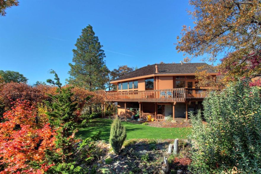 Designed by DeOrval Unthank, an architect who helped to shape the Pacific Northwest style, this 3,460 sq ft beautiful and unique home is set on 1.24 acres of gated and fenced prime tree studded property. Enjoy stunning perpetual 270 degree views over the Rogue Valley from the 1,200 sq ft of clear cedar decking and the perfectly placed windows in the light filled home. Vaulted ceilings of the entry level enclose window wall art gallery, lg living/dining rm, open kitchen, breakfast room, lg family room, and guest bathroom, all with easy access to beautiful deck living. Secluded NW wing master suite w/office loft above has sunken tub & exit to private garden & hot tub. At a level below are 3 large BR's, bathroom, sauna, lg utility rm & wine cellar space. All this completed by shop, 2 car carport/w storage space above. The property slopes gently to lawn, gardens, greenhouse and space beyond. This private & tranquil home is in a premium East Medford neighborhood - no through traffic.