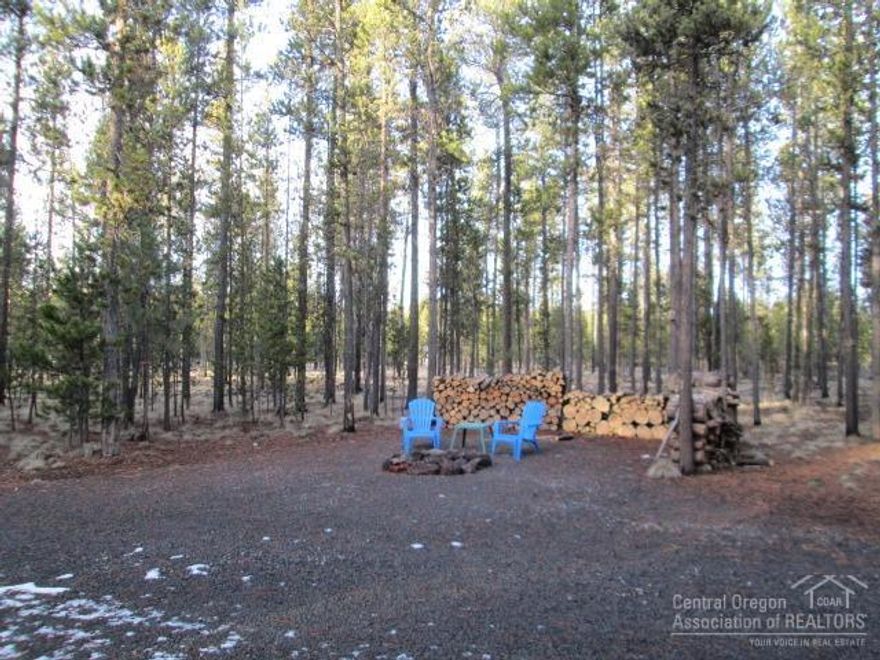 This property has two lots of record. Both lots join each other with own road frontage. Both lots have gone through fuel reduction and looks like a park. Improvements have four RV power hook-ups, one (50 amp) three (30 amp), lease propane tank with hook-ups, nice storage bldg., gravel drive way, and entertaining fire pit area. Propane tank is leased for $45.00 fer year. There is Bend Broad band service to the property, cable connections to both sites.