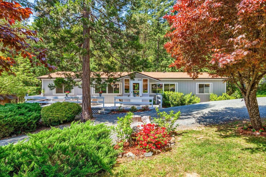 Creekfront oasis 6.36 acres with beautifully updated home, 2 car garage & workshop! The split plan home features 3 beds, den (c/b 4th bed & has a closet), 1848 sq ft, vaulted ceilings & open floor plan.  Upgrades in the last few years include new sheetrock, plumbing, lighting, heat pump & woodstove! Looks like new!  Skylights in the kitchen & primary bath bring in the natural light. The 2 car garage is insulated and has a work bench, built in shelves & cabinets.  The 20 x 20 workshop is finished, has water & is heated & cooled with a mini split system & would be great for multiple uses! The covered deck overlooks the creek & new bridge over the creek to access the back of the property, which backs to BLM!  Other exterior features include 10 x 14 shed with shelves, beautiful open meadow for gardening or watching wildlife, front deck to enjoy the beautiful yard & water feature circular driveway & gated entry.  Too much to list...a must tour!