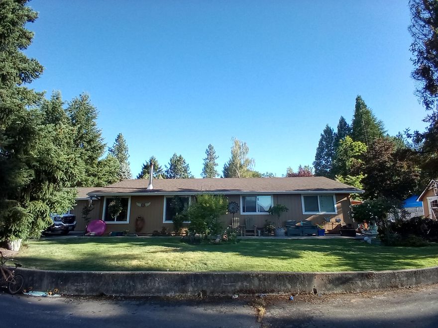 This property is located in a very desireable area and offers views of the beatiful mountains and city lights. 
 Vaulted ceilings thru-out large living room, dining & kitchen. LOTS of solid wood cabinetry, Big Laundry Room w/Utility sink. Beautiful brick hearth w/economic wood stove. Quality installed laminate flooring.New Roof,Bathrooms being updated with new vanities,All newer vinyl windows.New main Heat pump unit,along with additional mini split ductless unit for economical heating and cooling.. Very large Master. Attached bath w/double vanity & tiled tub/shower. All updated light & bathroom fixtures. Nice covered Patio with no maintenance concrete  Terraced Garden Beds w/perfect Southern exposure. Nice landscaping with underground sprinklers..New Storage shed for additional storage. Tons of built-in storage. Large parking area for guests,Neighborhood is quiet & mostly retired, Very desirable area. Area of newer homes. Well maintained.