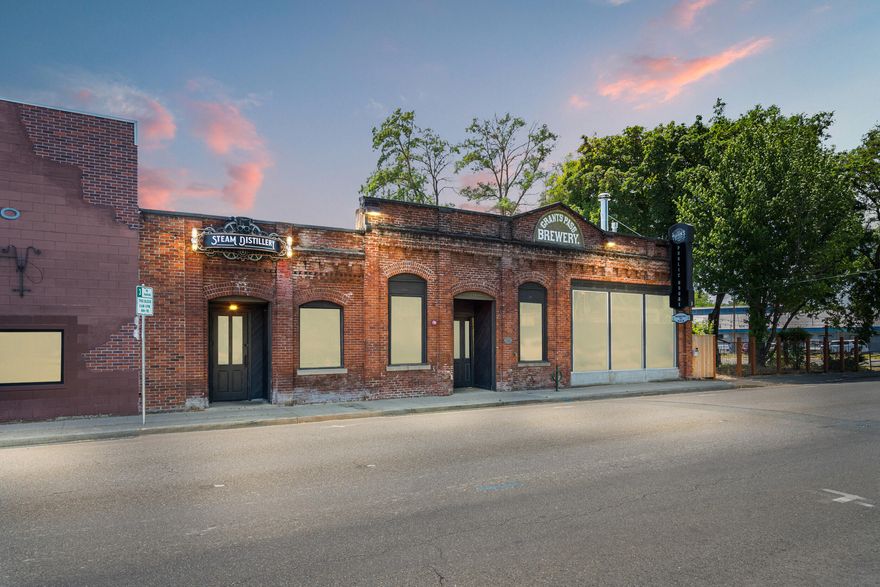 Discover a rare opportunity in downtown Grants Pass' vibrant Central Business District: the original Grants Pass Brewery location, now available for sale. Nestled creekside, this gem features the city's best patio—partially covered, including cozy gas fire pits, perfect for year-round enjoyment. The property includes a fully operational 10-barrel brewery, a spacious bar, full commercial kitchen, and ample parking. Steam Distillery currently leases a portion of the historic building, adding established revenue and charm. Whether you're an experienced brewer, restaurateur, or investor, this turnkey enterprise offers multiple income streams and a prime location. Creek views, fire-lit ambiance, and heritage architecture: this is more than a space—it's Grants Pass hospitality at its finest. Don't miss this exceptional chance to own a cornerstone of GP hospitality and make your own mark in the historic downtown.