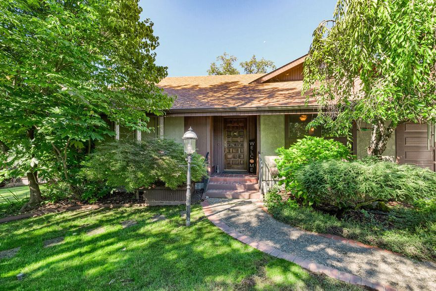 Take a look at this spacious home
Curb Appeal and perfect find in the Portola area.  Featuring a spacious 4 bedroom, 3 bath home with 3205 sf. on .21 of an acre.
The Cook will love the sunny and bright kitchen with an abundance of cabinets and dining area with slider to the large deck.  What a great spot for entertaining family and friends.  En-suite bedroom with walk-in closet and step in shower.  Laundry room with cabinets/storage.  Spiral staircase to the upstairs bedroom with living area and bathroom.  FA gas heat and Central A/C; free standing gas stove in living room.  Attached 2 car garage, off-street parking, covered carport, downstairs shop and office area with built-ins.  Fenced yard and convenient location close to schools, shopping and hospital.  Put this one on your list to show.  District 7 Schools.   Seller will provide a 1 year Home Warranty  for Buyers.  End of road walk.-in access to the Rogue River.  Let's go rafting.