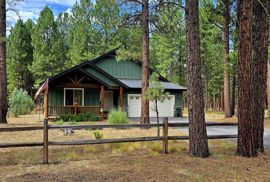 Experience the tranquility of nature with this stunning craftsman home nestled in the Pines on .46 acres with a unique backdrop of a privately owned 40 acres of forest, giving you privacy and abundant wildlife viewing opportunities. The 1497 sq. ft. residence offers 3 bedrooms, 2 baths, vaulted ceiling, an open floor plan of thoughtfully designed living space. Living room features a stunning river rock fireplace accented by tall windows overlooking the forest.  Kitchen has a entertainment/breakfast center island, easy access panty.  Step through the sliding glass door from the dining area to the spacious Trex deck where you can enjoy entertaining, peace, quiet, wildlife viewing, and all your imagination can dream of. The Main bedroom has its own bathroom and walk-in closet, the sliding glass door gives you access to the Deck and back yard. Laundry room has ample cabinet storage and leads into a spacious  garage.  This home has appeal, & is nestled in a very quiet small neighborhood.