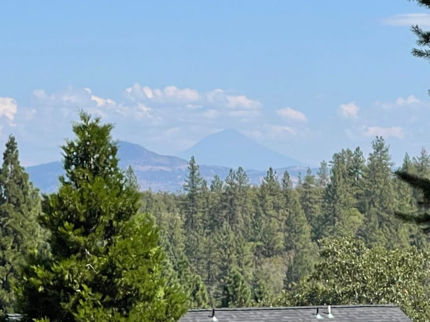 Rare opportunity just minutes from historic downtown Jacksonville! Granite Ridge offers sweeping views of the valley, Mt. McLoughlin, and sparkling city lights. This exclusive subdivision backs up to the Woodlands Trails, with over 13 miles of hiking right outside your door. The spacious .42-acre lot comes with full city services, including gas and cable. Just a half mile from the Britt Festival and downtown Jacksonville, you'll enjoy easy access to live music, boutique shopping, and top dining. With only 9 total lots in Granite Ridge, this quiet and private setting is the perfect place to bring your builder and create your dream home. Properties like this are rarely available—don't miss your chance! Build to suit option available. Please call for more details.