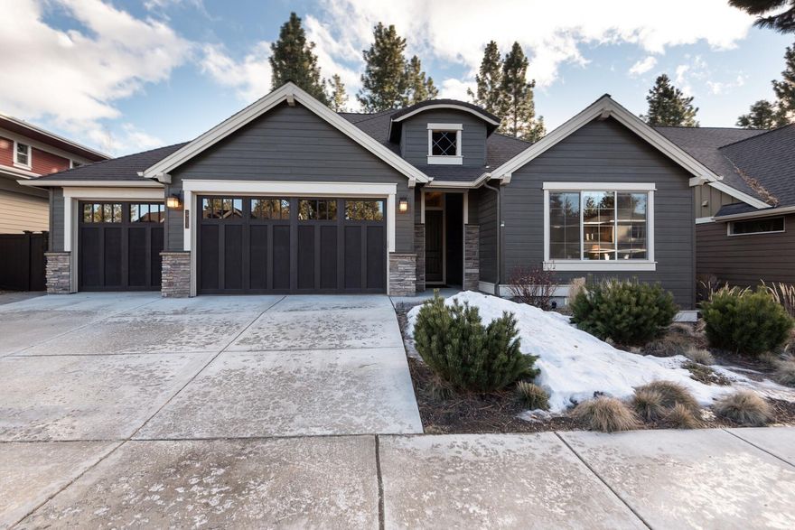 Warm, inviting and impeccably maintained, this single-level Pahlisch home features high-quality upgrades, luxury finishes and a private outdoor setting lined with tall pines and evergreens. Dramatic, vaulted great room is anchored by a grand, stacked-stone fireplace with custom knotty-alder cabinetry. Huge floor-to-ceiling windows bring in plenty of natural light and look out onto a large, covered patio surrounded by an expansive, beautifully landscaped, low-maintenance backyard. Chef's kitchen is open and spacious with eating bar, walk-in pantry and dining area. Primary Suite has coffered ceilings, a private outdoor entrance and a luxury tiled bath with soaking tub and walk in closet. Second master/junior suite with ensuite bath. Third bedroom is huge and offers flex space for a bonus room/office. Central vac, large 3-car garage with quality storage cabinetry. Fabulous NW location near schools, hiking and biking trails, parks, amenities, shopping and all just minutes to downtown Bend.