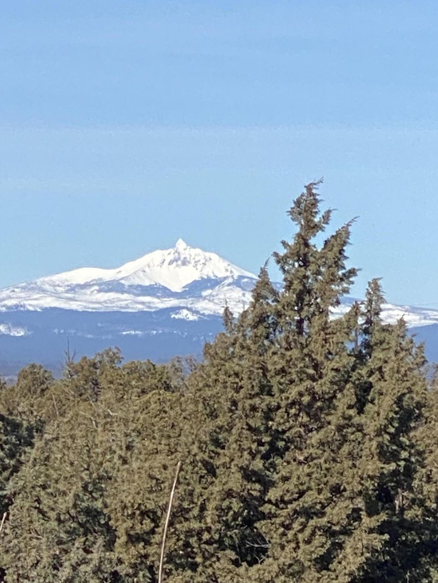 Welcome to 998 Trail Creek Drive, on a corner lot, with a wide, flat driveway leading to a 3 bay garage. This contemporary Northwest style home is full of things to love. Main level primary suite opens to back patio & has a view of neighborhood pond beyond the property line. A large walk-in closet, soaking tub & double vanity offer great space for a busy morning or relaxation. On the opposite side of the great room there are 2 more bedrooms & bathrooms; one bedroom with a Mt Hood view is currently an office. Upstairs huge bonus room could be a second primary suite. Or highlight the wet bar area and create a game or tv room for additional living space. Enjoy sunsets over the mountains, Broken Top to Mt Hood, on the upstairs balcony. Back on the main level, the slab granite kitchen counters, stainless steel appliances & new range are ready for you to move in and cook. Remote operated blinds are fast and easy when you want a change in ambience. Hiking trails & paths outside your doors!