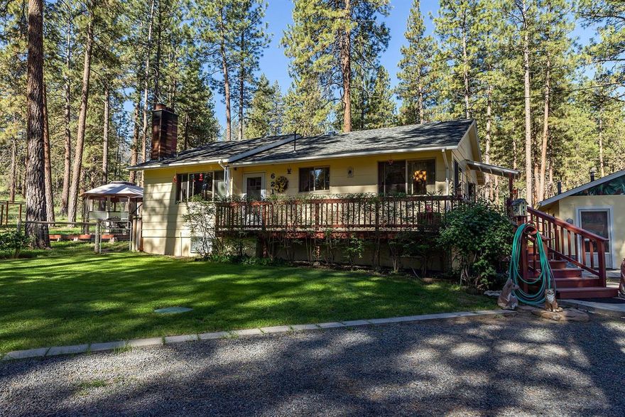 Gorgeous setting on 2.33 acres with circular drive, lush green grass and tall stately Pine trees. Very well kept and private, this lovely 4 bedroom 1 bath home has over 2,100 sq.ft. with many upgrades including remodeled kitchen with new tile counters, new faucet and sink, and appliances. Laminate flooring in LR with cozy wood fireplace. Remodeled bathroom, big rec/family room down stairs. Heated garage, 20x20 machine shed, game bird house and fencing. Nice deck for entertaining and enjoying the cool evening breezes. In the country, yet only minutes from the quaint town of Bonanza.