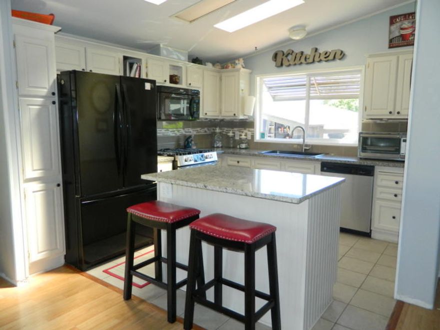TotallyUpdated, Light & Bright and a delight to see.  Located in 55+ park.  2000 Skykine with 1150 sqft.  3 bdrm 2 bath home with open floor plan,Spacious Living room, Dining with French Doors,  kitchen has a splash of granite, painted cabinets and New Appliances.  Gas Range, Dishwasher and Frig.  Laminate flooring, Large master with updated bathroom with walk in shower, and so much more.  Patio, Artificial Turf, Raised beds full of Vegetables, Shed and fenced for small dog.  Don't miss out on the opportunity to own this home.  Monthly Rent is $655. includes water.  Monthly charge for sewer and garbage is $24.75.
