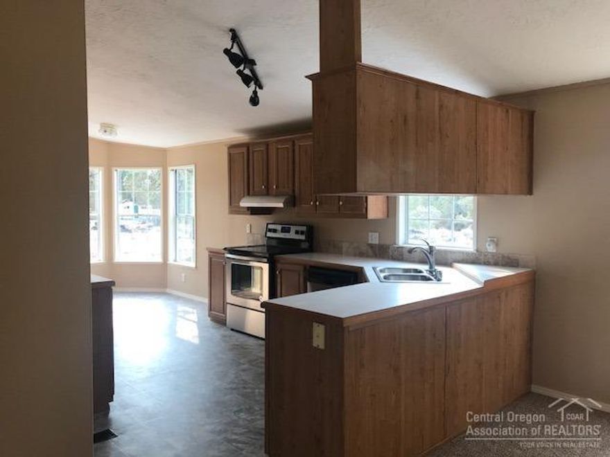 Affordable, do not miss this one! Just renovated - new roof, carpet, appliances, interior and exterior paint and a beautiful new front wood deck and porch. Enjoy the concrete patio in the back. Home features a well laid out floor plan with breakfast nook, office and 3 bedrooms. Shows like new and all of this on 5 acres. Private well and a chicken coop. Circle driveway and plenty of room to build a shop. Your buyer will appreciate this one. Tie downs are completed. Move in ready!