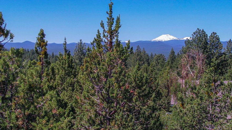 Imagine standing atop one of the highest points in Bend, surrounded by breathtaking panoramic views that stretch from Pilot Butte and the Old Mill to the majestic peak of Mt. Bachelor. This ¾-acre parcel in Awbrey Butte is more than land—it's a rare vantage point, a place where the world unfolds before you in stunning detail. By day, soak in the rolling valley below; by night, watch the city lights flicker like stars beneath your feet. Native plants and rock outcroppings as set for a natural backdrop.
Now, this extraordinary piece of Bend is more attainable than ever with a recent price reduction—an opportunity you don't want to miss. Bring your plans for an accelerated  start given the property has the required surveying, topo, engineering for the driveway and water management already  in place. The stage is set for something truly remarkable.
Don't wait—call today and walk this stunning property yourself. The view is waiting.