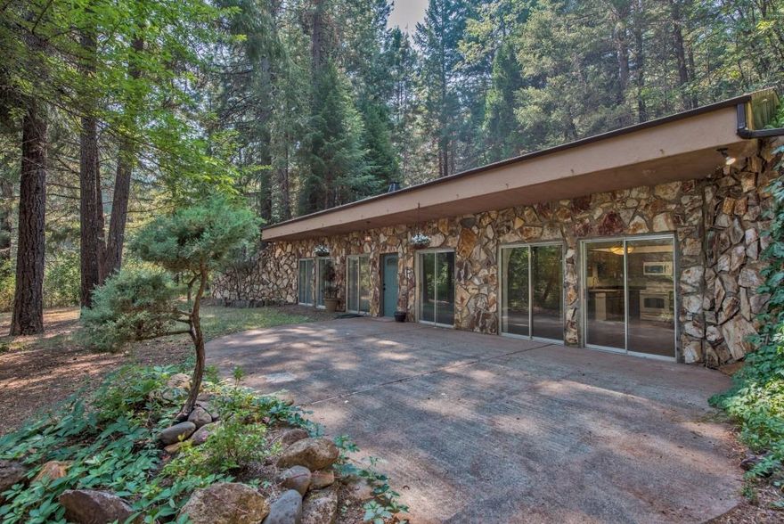 Serene, private location on 5 wooded acres w/ marketable timber. Cozy, solid built 3 bedroom, 2 bath home with 1814 sq ft, offers lots of natural light from the large windows & engineered concrete construction, newer commercial grade roof, newer paint, flooring & appliances. Large barn/shop area & covered carport. Very scenic & pleasant 45 minute drive from Medford. Well maintained & paved drive to the property. Owner may carry a First Deed of Trust with at least $155,000 down.