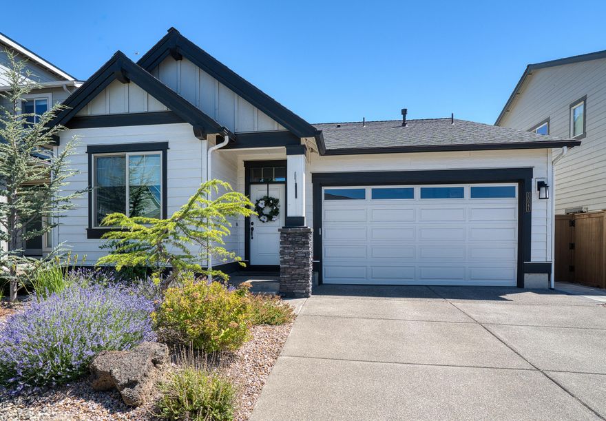 Coveted, one level home in The Bridges neighborhood where you can access miles of trails right from your front door. This stylish home also sits across the street from 37 acre Alpenglow Park. Highlights of the Wagner plan include a center island and abundant cabinet storage with pullouts in the kitchen, clerestory windows and gorgeous stone fireplace in the vaulted great room, a junior suite, dedicated laundry room, and covered back patio for enjoying Bend's warm summer nights. Better than new with lots of upgrades like power remote silhouette blinds and shades, air conditioning, and more.