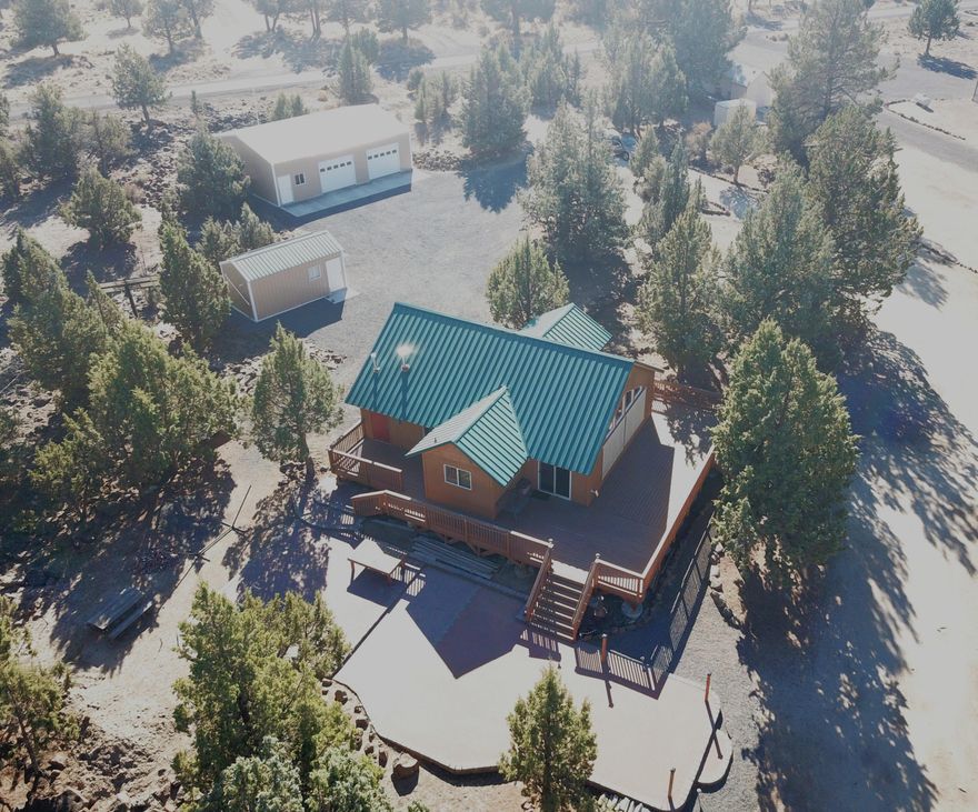 Great opportunity to own a piece of 3 Rivers in this 2006 stick-built open concept 2B/R,1BA, + great room Cabin. High end finishes are the norm, fully furnished and move-in ready w/tons of storage, 1000+ sf of wrap around decking +1200 sf of finished paver patio for entertaining---w/propane AND separate wood fire pits included. All permitted and move-in ready. New owned solar system w/2600 watts of PV panels and NEW batteries inside newly built 10' X 20' mechanical
building. New 30' X 40' shop with 2 garage doors 10'w X 8'h + man door, concrete floor & electricity. Peek of Mt. Jeff views on this dead-end street w/2.27 acres so lots of room to grow. Seller is also including their marina slip #321 in the sale. Come enjoy all that 3 Rivers has to offer: private Lake access, gated community, rifle/pistol/trap shooting range, pickle ball courts and much more. Call your favorite agent today for a showing. Don't let this one slip away.