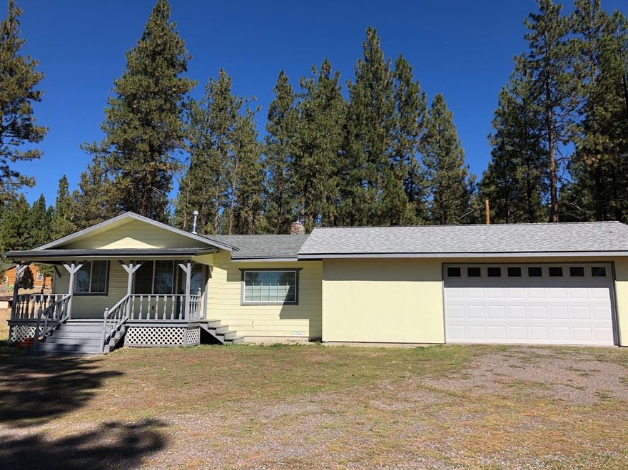 Cute 2 bedroom, 1 bathroom home situated on 1.47 acres. Featuring an open living room with rustic rock fireplace, wood stove, plus propane heater. The kitchen has newer cabinetry, counter tops, and appliances. Large mud room with laundry. Newer carpet and roof. The attached 2 car garage has space for potential 3rd bedroom, plus workshop area. Exterior features include a wood shed, storage shed with roll up door and concrete floor, attached to the pump house. Water filtration system/ softener is also newer. Additional workshop behind the house was used as a chicken coop with separate storage room and power available. Property was recently surveyed, and Neighboring lot may be available with purchase of home, firewood excluded.