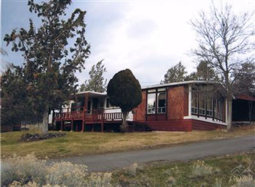 Such Potential! Top of line silvercrest on one acre lot! 2 bed, 2 bath plus dining, living and family room. Double wall ovens, range top and wall of windows with lots of natural light. Built in hutch and gas fire place. Brand new carpet. Sloped lot with gravel drive leading to 18 x 24 garage. Heat pump and newer septic tank. Two storage sheds. Enjoy all the Crooked River Ranch amenities!