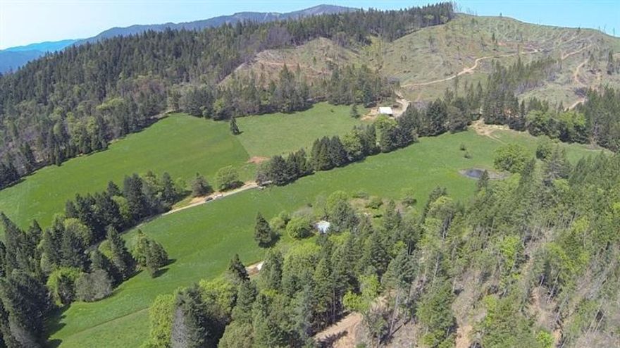 Live on the land and more literally! This 240 acre property is hard to beat with its many uses and versatility. This easily can be a 2 to 3 family setup which is secluded on Forest and Farm land. Original house on property offer pastures for cattle, orchard, 5 ponds on property with irrigation and public utilities for power and phone. This property has tons of wood already to be taken away in piles for firewood350 Board Feet of marketable timber! There is a brand new barn for cattle with cattle land fencing. Lots of water, views of the valley and meadows and this property also has one of the largest madrone trees! All roads re-rocked, natural wildlife, seclusion and natural resources to live off the land. Too many extras to list. Appointment only to your Oregon Paradise just 15 minutes off the interstate 5 freeway. This is one of those rare properties and not a drive by! Make your appointment to view today. Serious buyers only please.