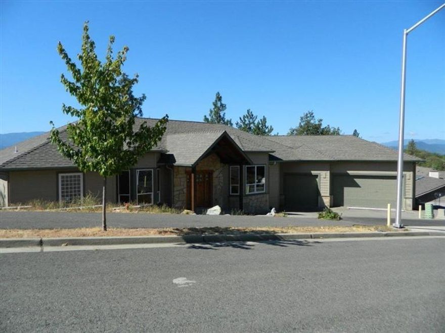 Southern Exposure, Stunning Views and Spacious home in Forest Hills Subdivision in NW Grants Pass. Formal Stone entry. First floor features 12' ceilings, living room, hugh kitchen, formal and informal dining, Master bedroom with private bathrooms & walk in closets, Den & laundry room. Daylight basement has 2 bedrooms, bathroom and family room. Decks have unobstructed views overlooking the city, mountains and Upper River Rd Valley. Over sized 3 car garage. House is to the drywall stage, just waiting for the finishing touches, purchaser to finish the home to their specifications. the house does not have any bathroom fixtures or cabinets. it is just the shell.