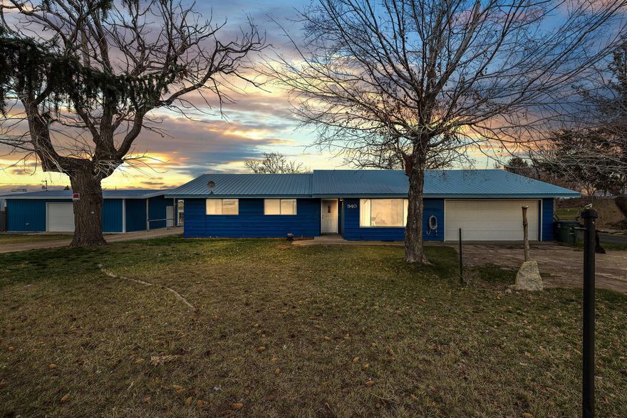 Lovingly maintained and beautifully updated, this single-level charmer sits just outside of town on 1.8 acres (2 tax lots) with 1.4 acres of irrigation rights. A rare find, it boasts TWO spacious shops (each with 50 amp service, one heated) and an asphalt wrap-around driveway with a unique built-in fossil display. Inside, the 1,411 sq ft home offers 4 bedrooms, 1.5 baths, and a generous living room with a cozy wood-burning fireplace. The kitchen has been thoughtfully updated with modern appliances and new laminate flooring, while fresh exterior paint in recent years adds to its appeal. Comfort is ensured with forced air heat and central A/C. Additional highlights include an
attached 2-car garage, laundry room with ample storage, and a large covered patio overlooking naturally landscaped grounds. A property filled with care, charm, and endless potential!