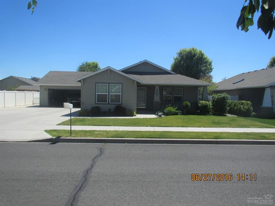 Open floor plan with a gas fireplace in the great room, 1629 sq. ft. 3 bed, 2 bath split floor plan,office/bedroom with double doors.Master suite separate from the other bedrooms for privacy with a door out to the back patio. Property is beautifully landscaped including an automatic sprinkler system. An attached 2 car garage with a RV area and room for all your toys! Gorgeous views of Barnes butte and surrounding mountains, a must see.
